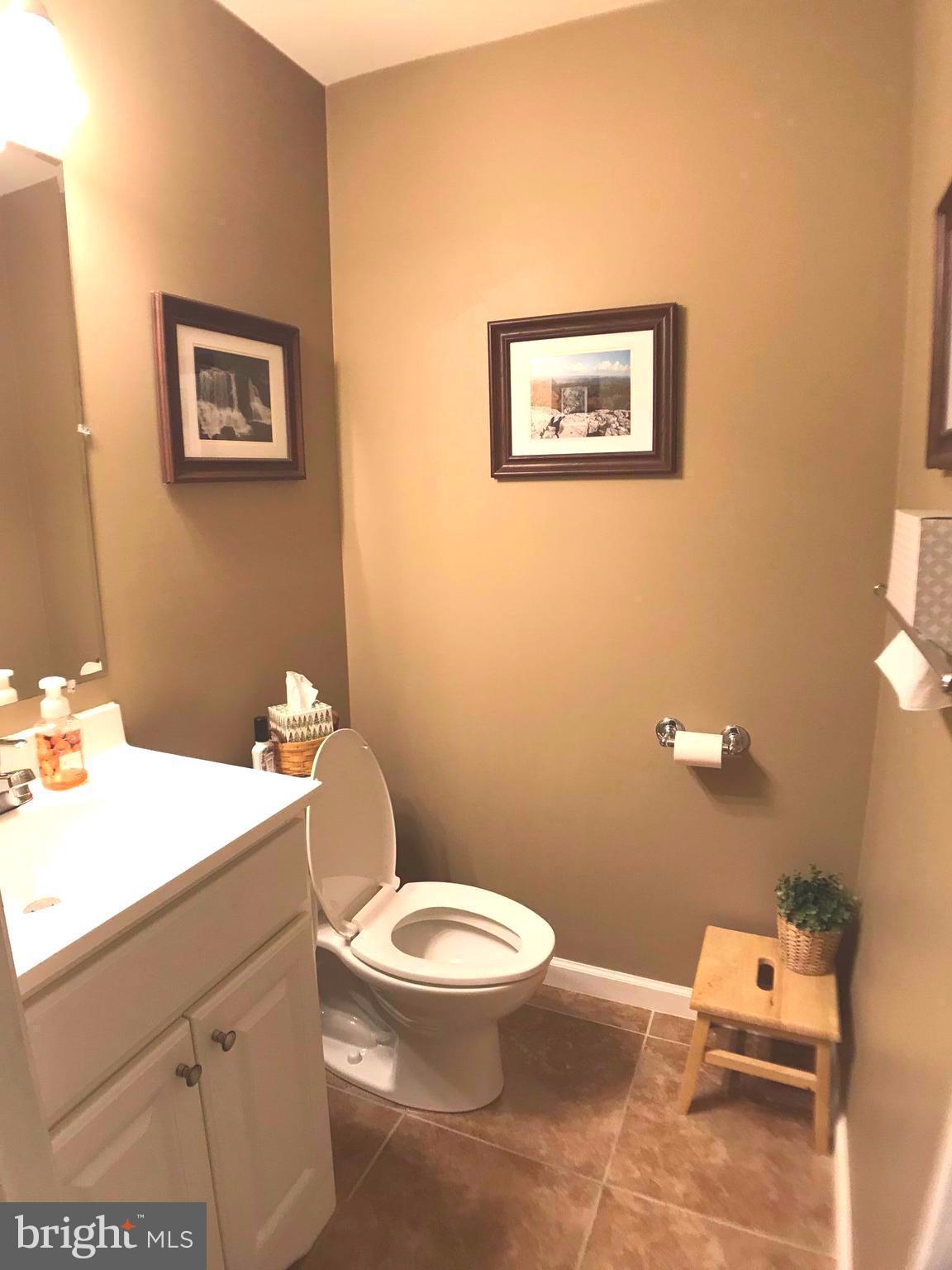 2313 Ruth Avenue Baltimore, MD 21219 - Photo 9 of 25 a bathroom with a toilet a sink and mirror