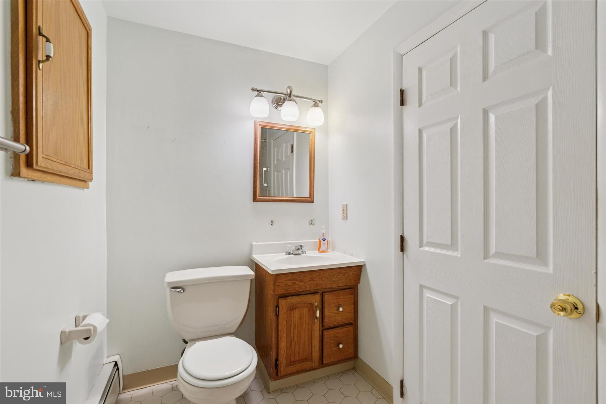 18 Lloyd Avenue Downingtown, PA 19335 - Photo 19 of 24 a bathroom with a toilet sink and mirror