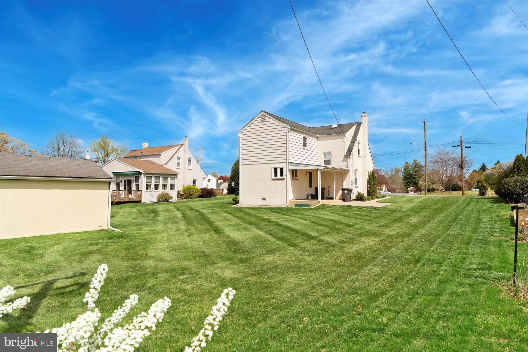 18 Lloyd Avenue Downingtown, PA 19335 - Photo 4 of 24 a view of a big house with a big yard plants and large trees