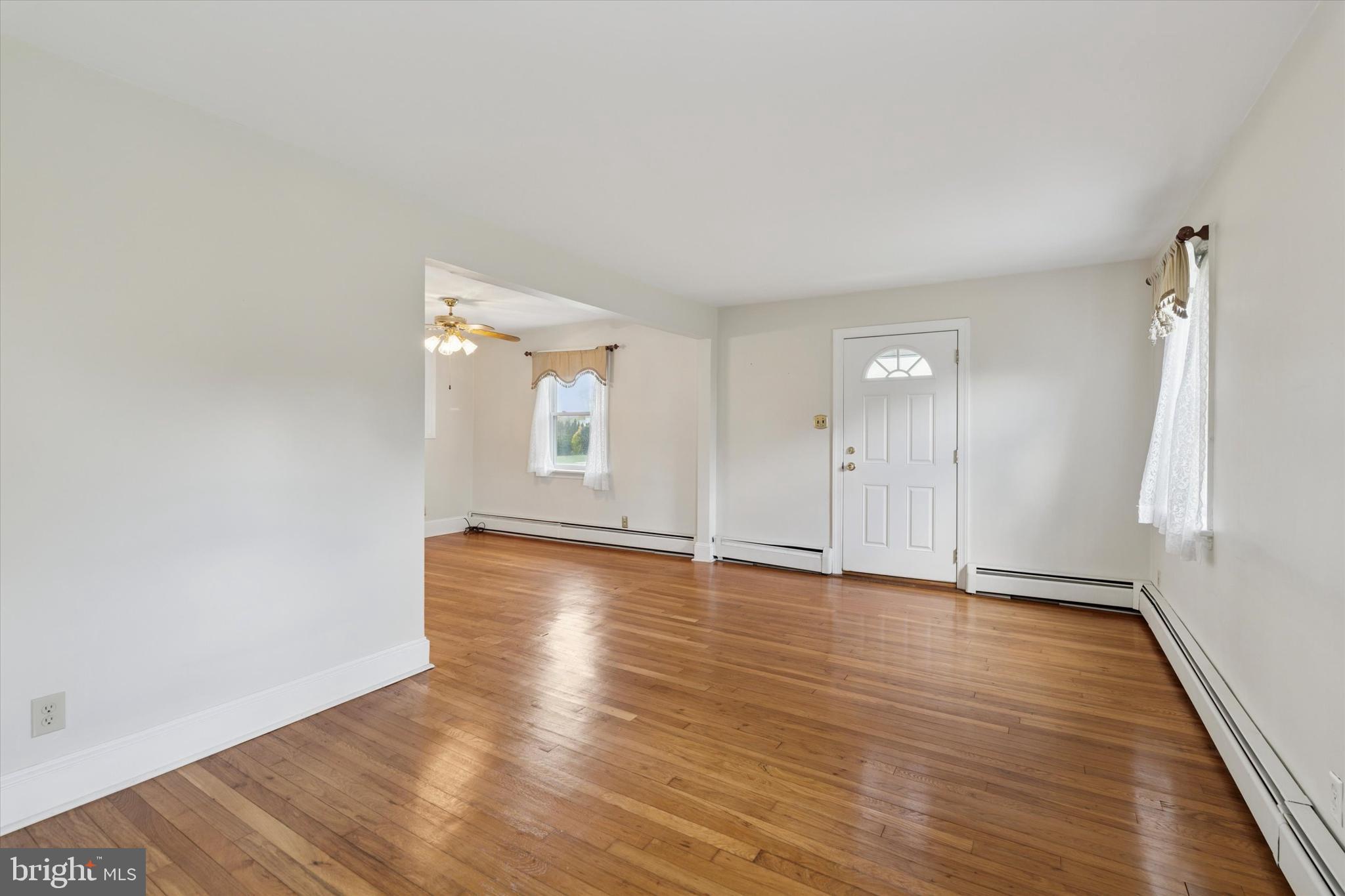 18 Lloyd Avenue Downingtown, PA 19335 - Photo 6 of 24 an empty room with wooden floor and windows