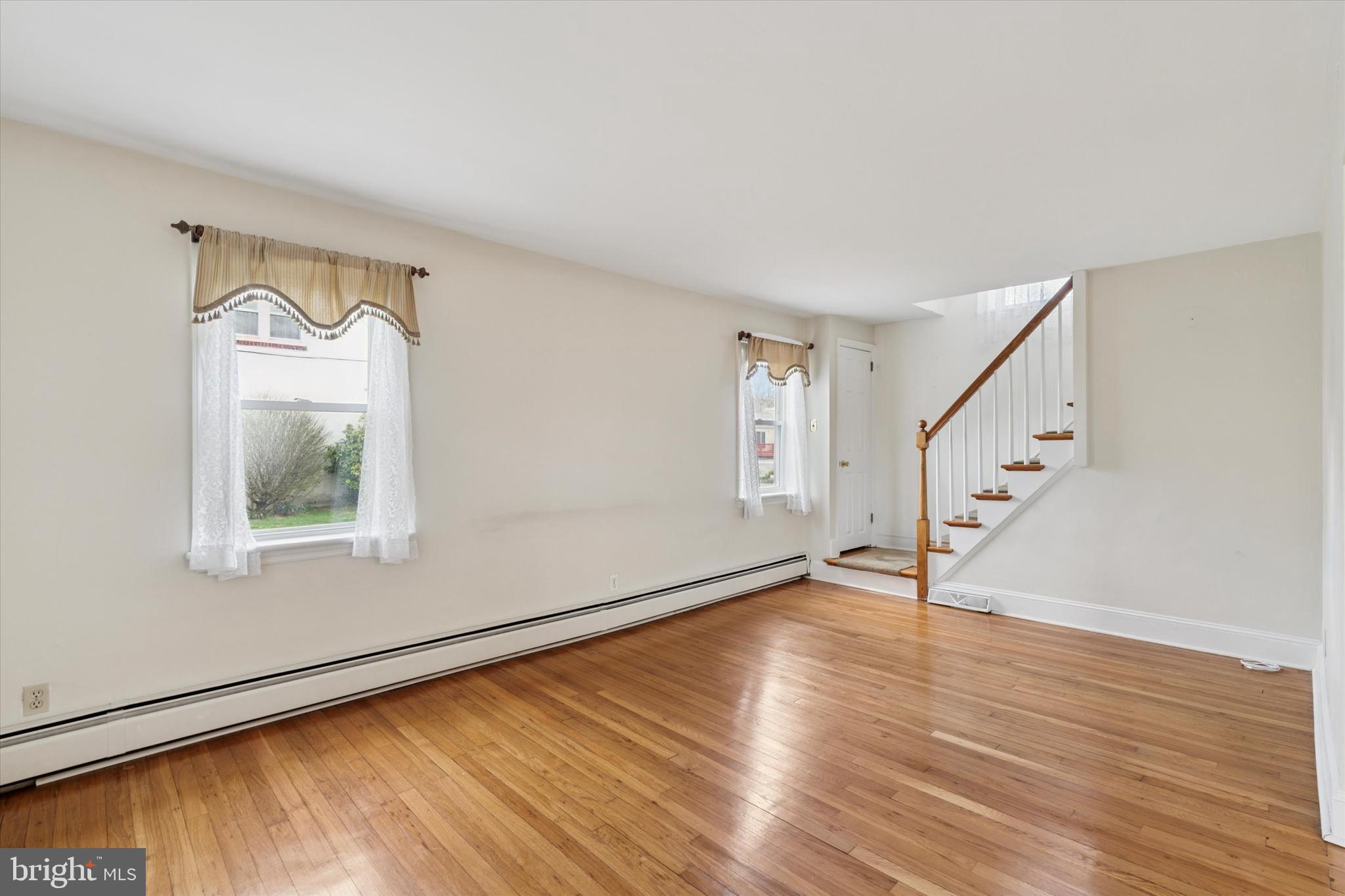 18 Lloyd Avenue Downingtown, PA 19335 - Photo 7 of 24 a view of an empty room with wooden floor and a window