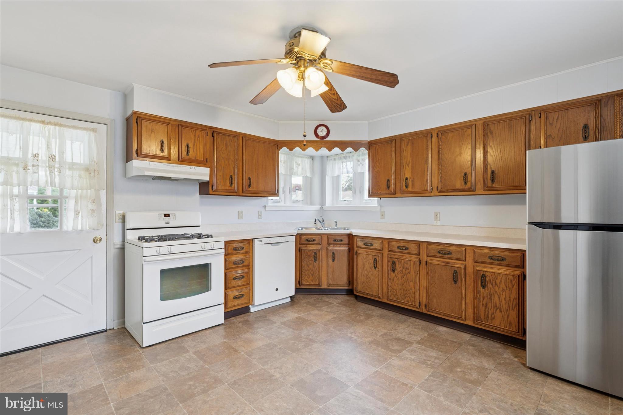 18 Lloyd Avenue Downingtown, PA 19335 - Photo 10 of 24 a kitchen with cabinets stainless steel appliances and a window