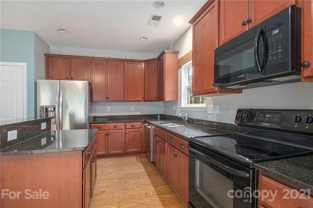 1637 Beleek Ridge Lane Clover, SC 29710 - Photo 3 of 39 a kitchen with stainless steel appliances granite countertop a refrigerator stove top oven and sink