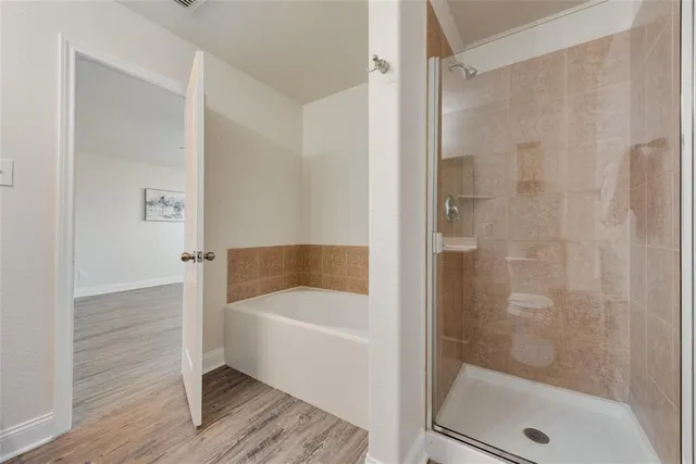 a bathroom with a shower and bathtub