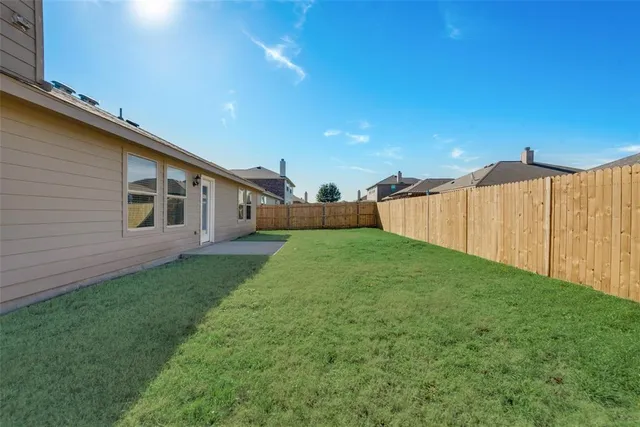 a view of a backyard with plants and a garden