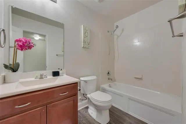a bathroom with a sink vanity mirror and toilet