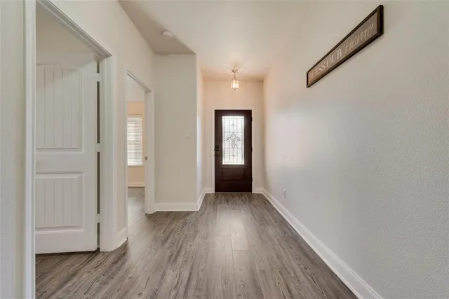 a view of hallway with wooden floor