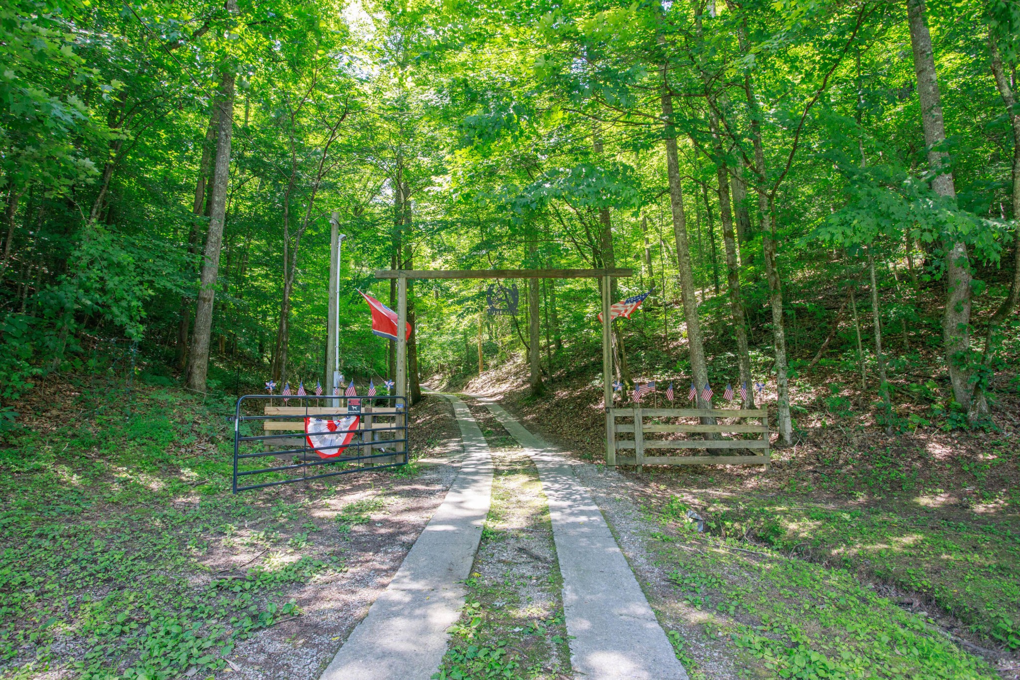 2031 Sulphur Springs Road Clinton, TN 37716 - Photo 2 of 31 a view of a park with large trees and a barn