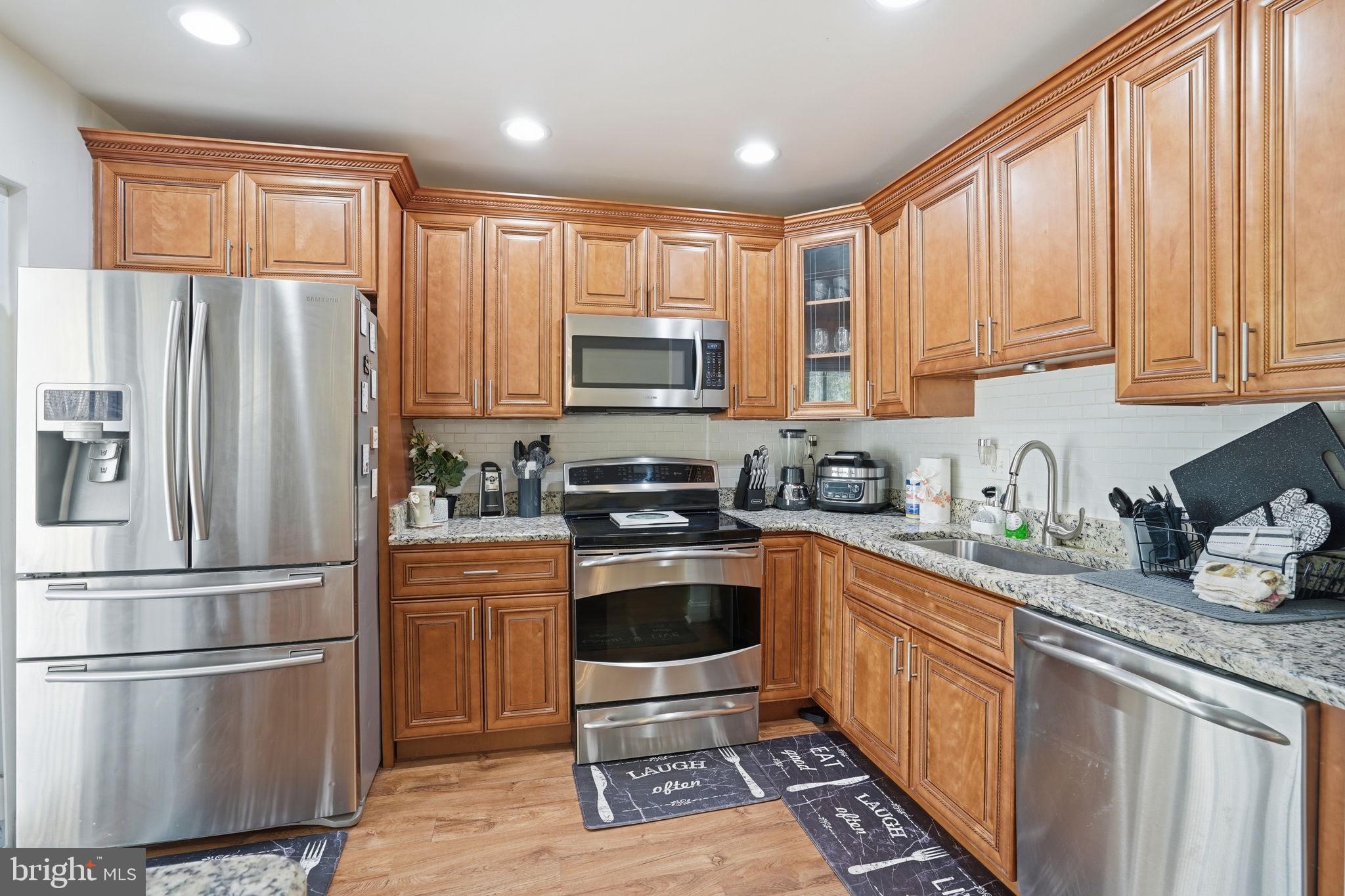 12 Sundown Court Baltimore, MD 21206 - Photo 7 of 29 a kitchen with stainless steel appliances granite countertop a refrigerator sink and cabinets