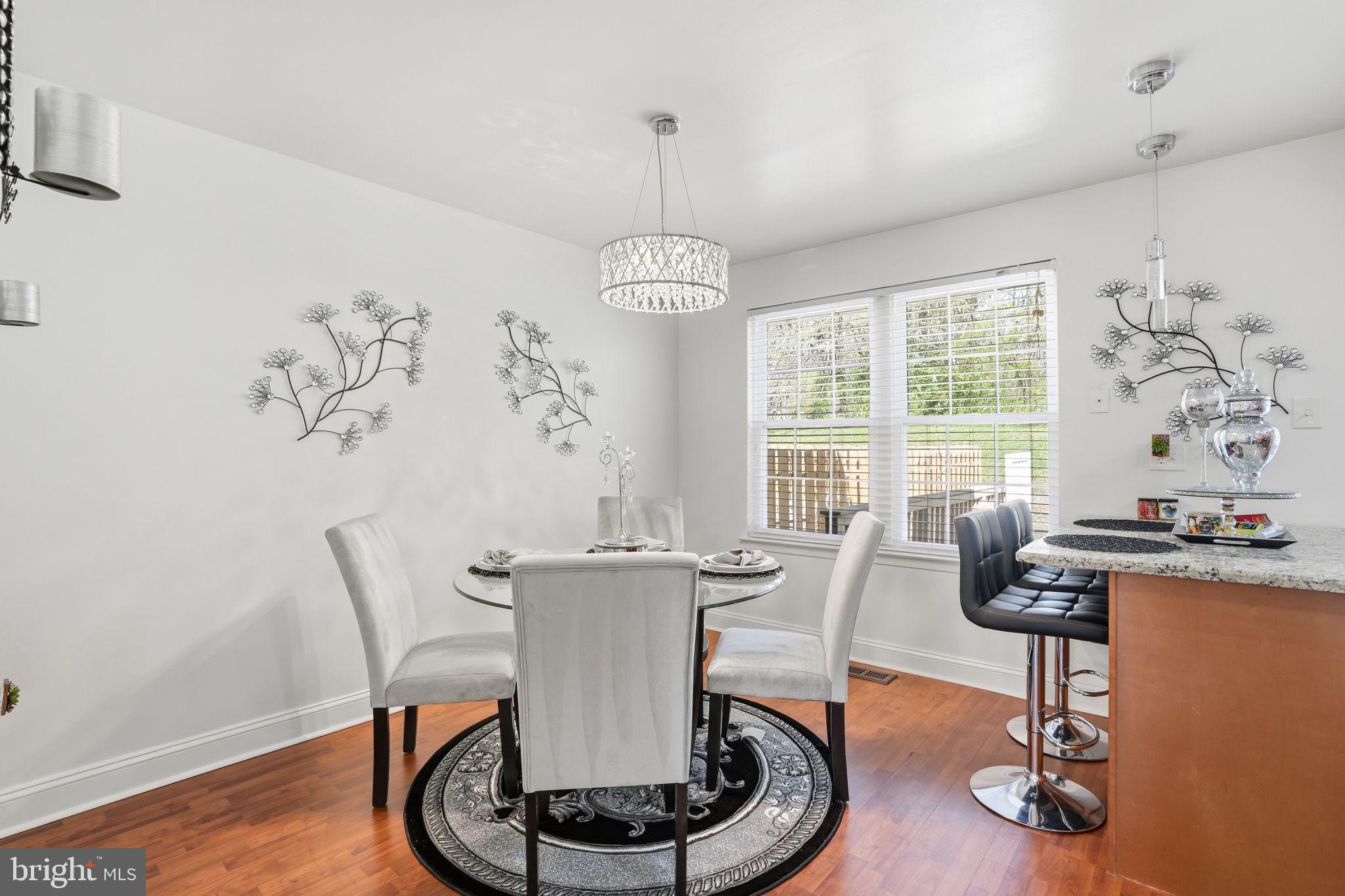 12 Sundown Court Baltimore, MD 21206 - Photo 10 of 29 a dining room with furniture wooden floor and a chandelier