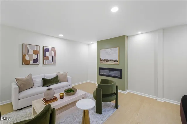 a living room with furniture and a potted plant