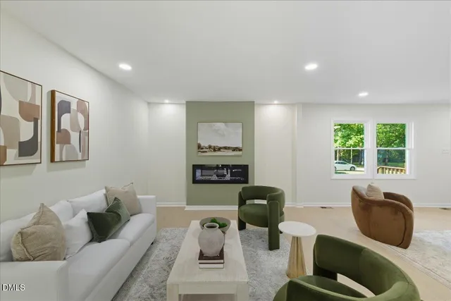 a living room with furniture and a wall painting