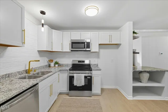 a kitchen with a sink stove and cabinets