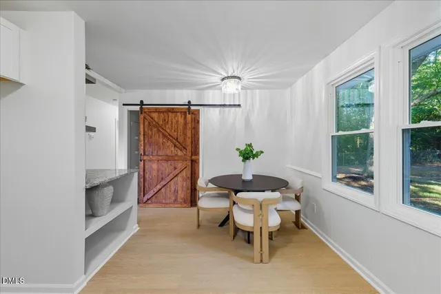 a dining room with furniture and window