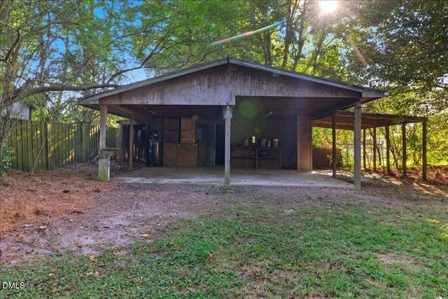 a view of a big house with yard and a large tree
