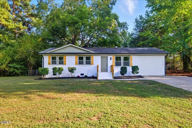 a front view of a house with a garden and patio