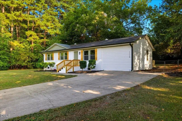 a front view of a house with a garden