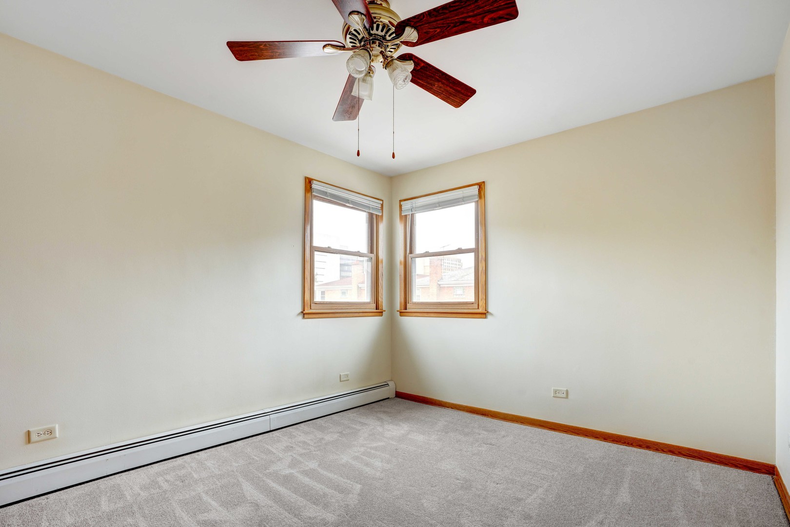 8444 West Gregory Street, Unit 3B Chicago, IL 60656 - Photo 6 of 9 an empty room with a chandelier fan and windows