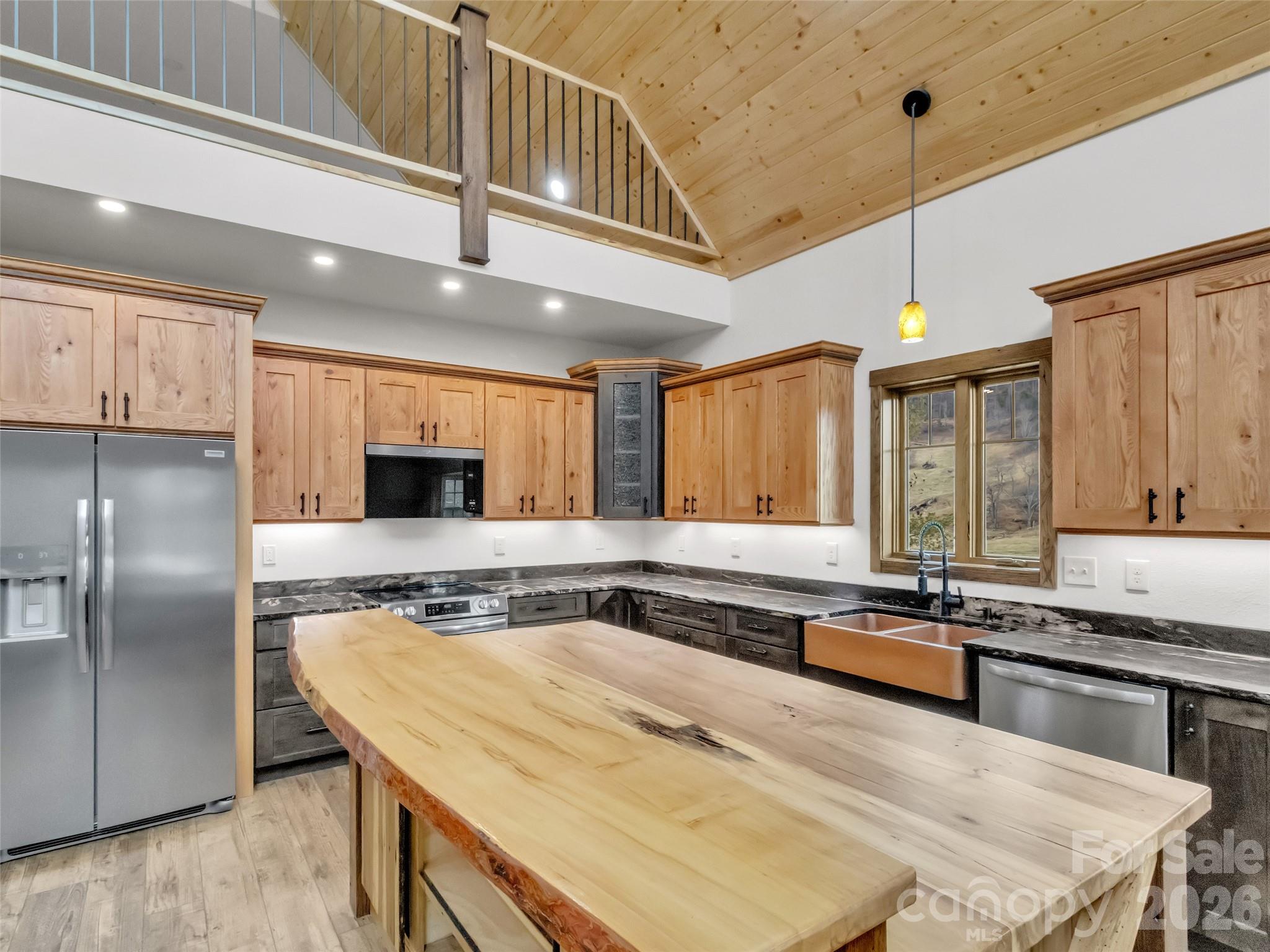171 Cowtail Cove Clyde, NC 28721 - Photo 7 of 48 a kitchen with stainless steel appliances granite countertop a sink a stove and a refrigerator