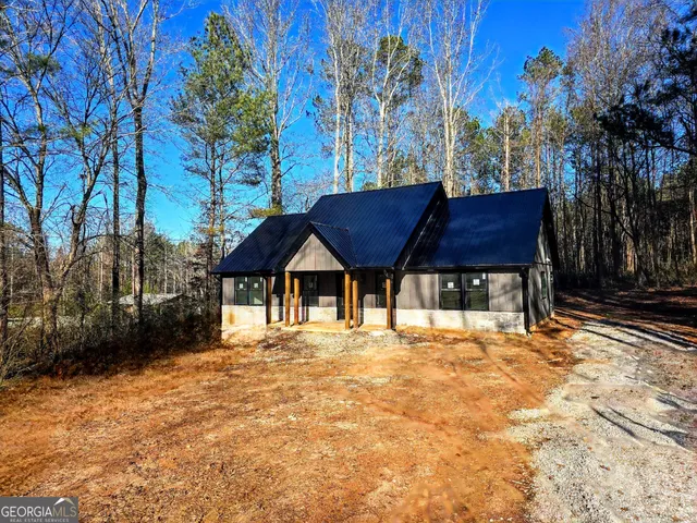 a wooden house with trees in front of it
