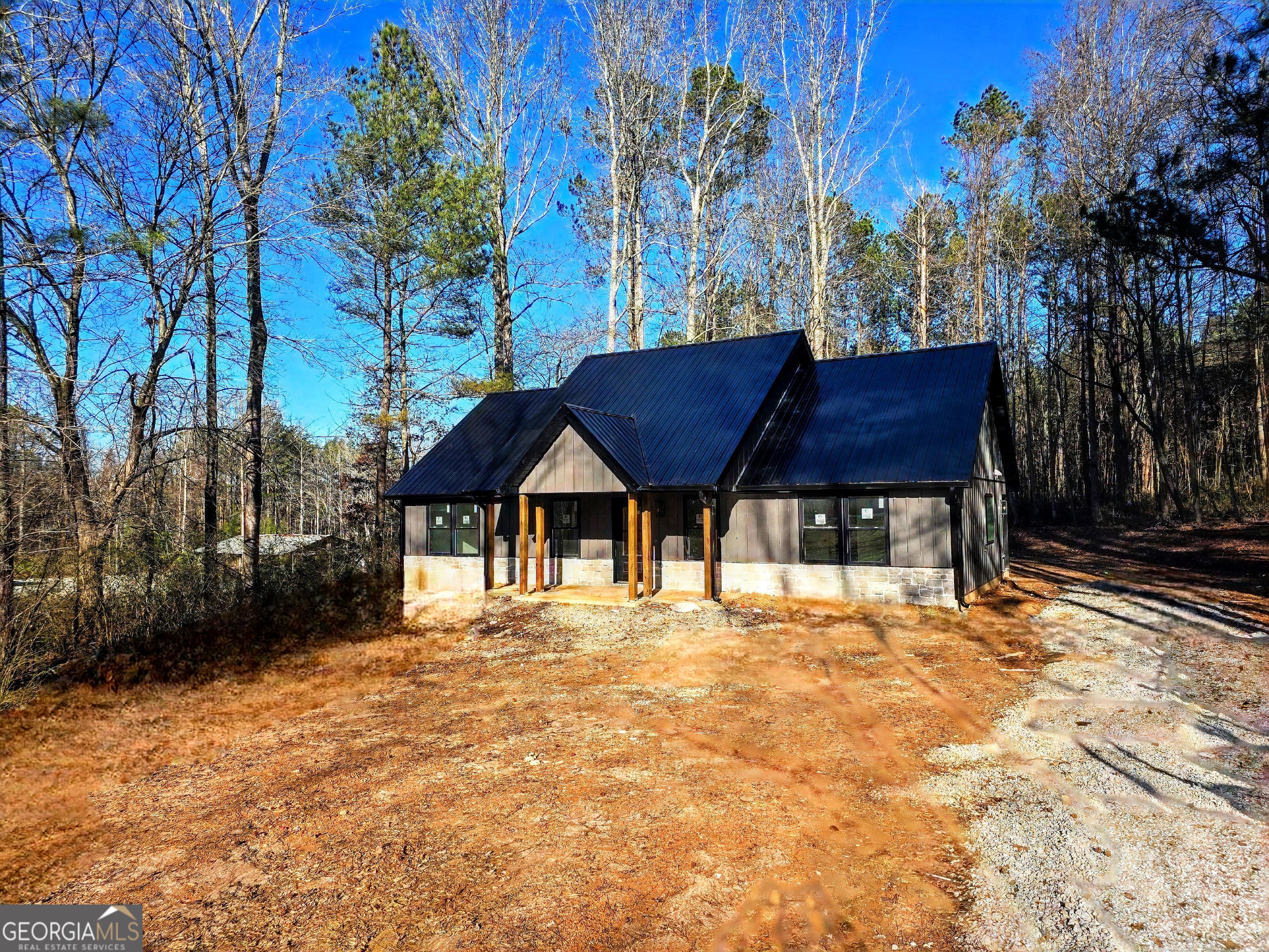 266 Center Point Road Bremen, GA 30110 - Photo 2 of 23 a wooden house with trees in front of it