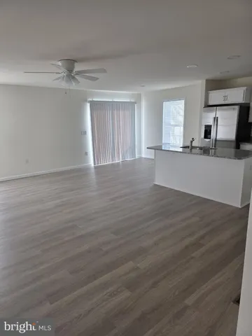 a view of a room with wooden floor and windows
