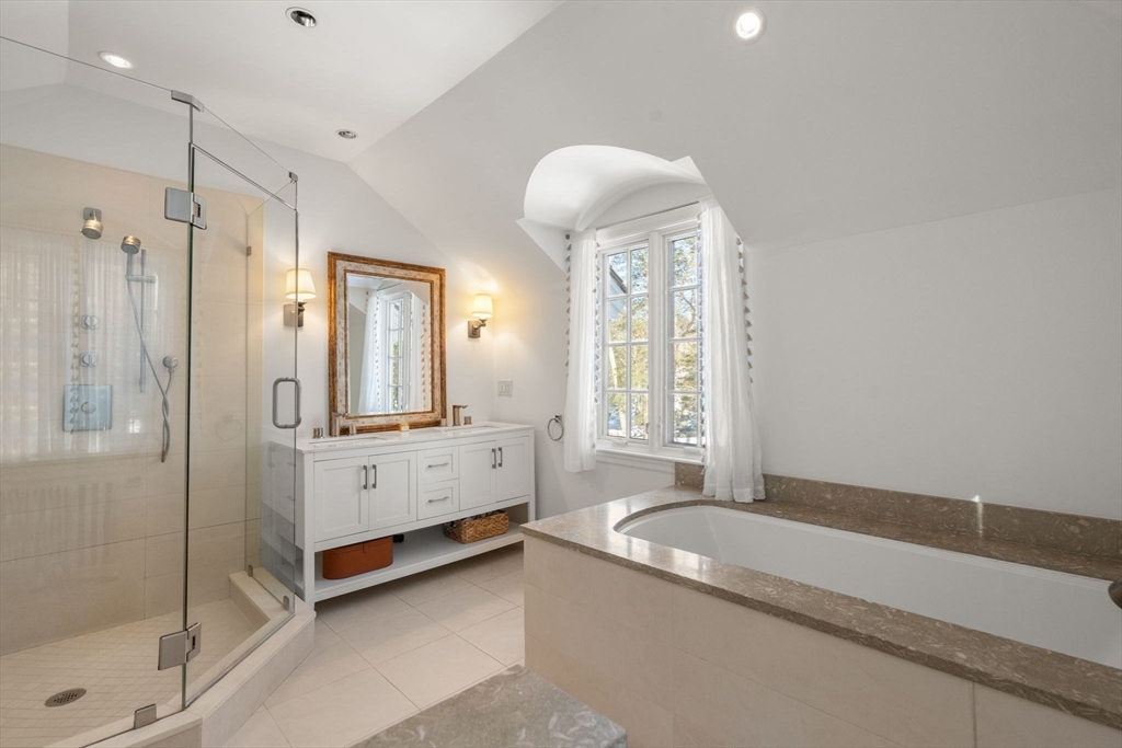 24 Colonial Way Weston, MA 02493 - Photo 18 of 32 a spacious bathroom with a tub sink shower and mirror