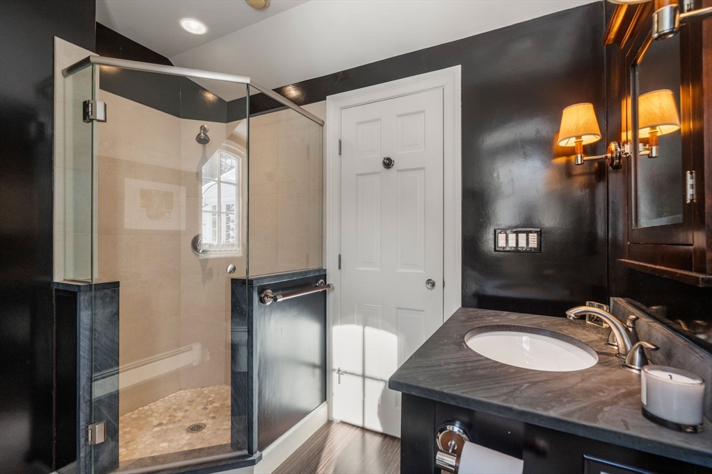 24 Colonial Way Weston, MA 02493 - Photo 24 of 32 a bathroom with a granite countertop sink a mirror and shower