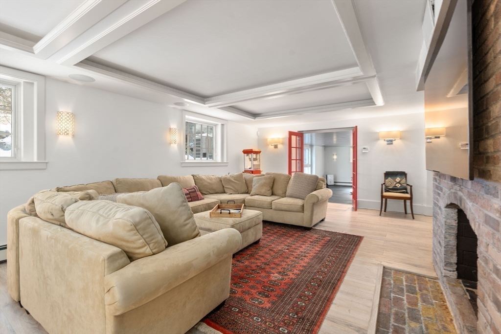 24 Colonial Way Weston, MA 02493 - Photo 26 of 32 a living room with furniture and a fireplace