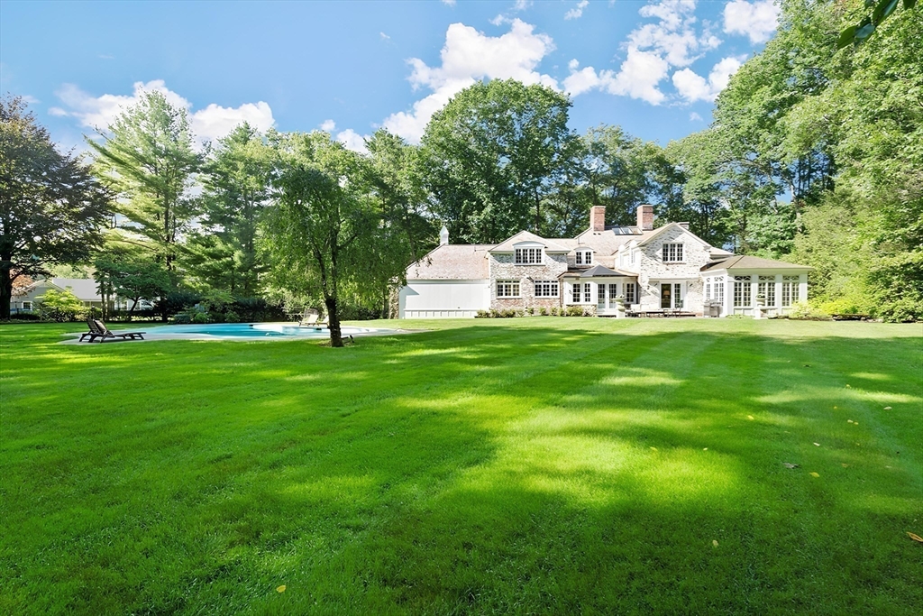 24 Colonial Way Weston, MA 02493 - Photo 31 of 32 a front view of a house with garden and trees