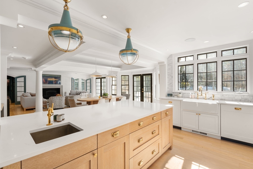 24 Colonial Way Weston, MA 02493 - Photo 5 of 32 a very nice looking kitchen with granite countertop a stove a sink a dining table and chairs with wooden floor