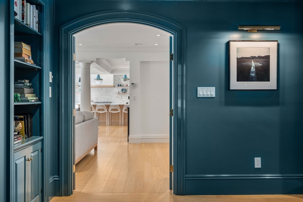 24 Colonial Way Weston, MA 02493 - Photo 7 of 32 a view of a hallway with wooden floor and a living room