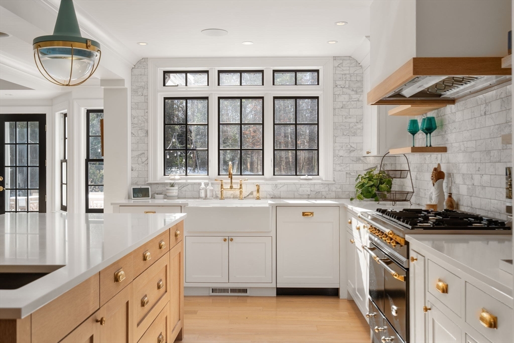 24 Colonial Way Weston, MA 02493 - Photo 8 of 32 a kitchen with granite countertop a stove and a sink