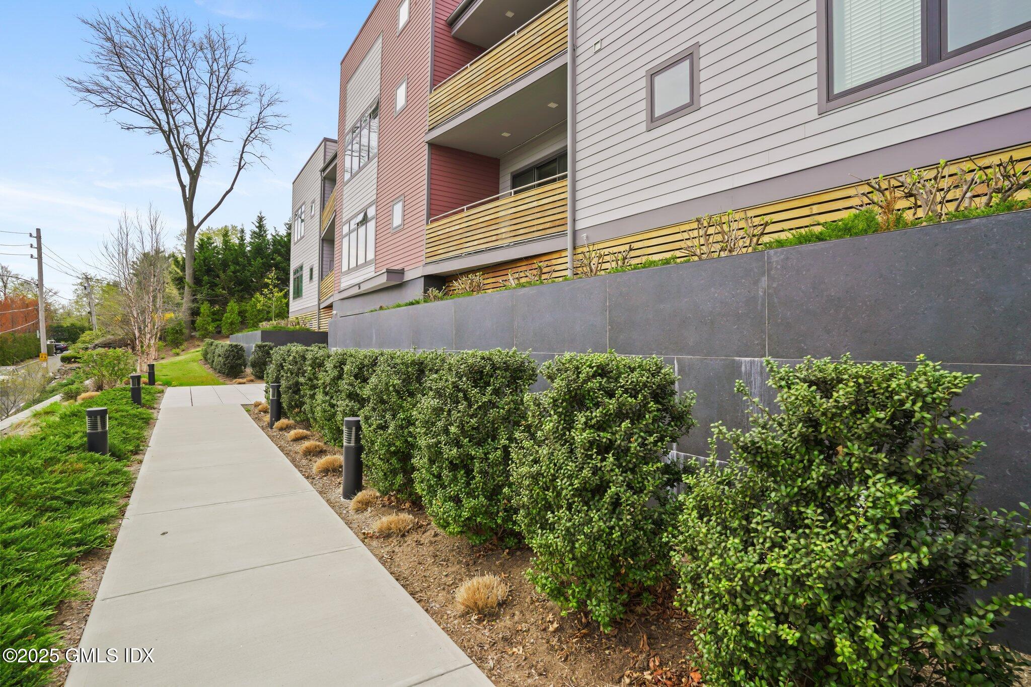 56 Old Field Point Road, Unit 2 Greenwich, CT 06830 - Photo 19 of 20 a view of a garden with pathway