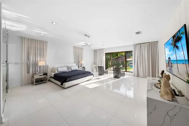 a living room with furniture a window and a flat screen tv