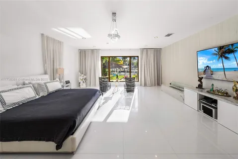 a large living room with stainless steel appliances granite countertop furniture a fireplace and a large window