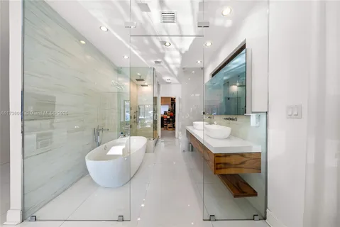 a spacious bathroom with a tub and mirror