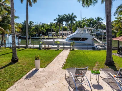 a swimming pool with barbeque oven outdoor seating yard and green space