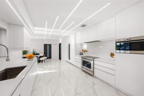 a kitchen with stainless steel appliances a stove a sink and a refrigerator