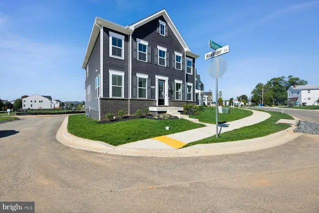 a view of a brick building next to a yard
