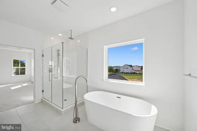 a bathroom with a white tub a shower and a sink