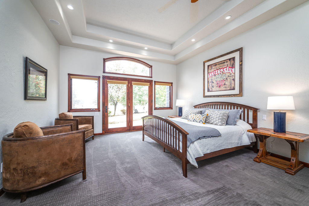 60675 Billadeau Road Bend, OR 97702 - Photo 20 of 87 a spacious bedroom with a bed a couch and a window