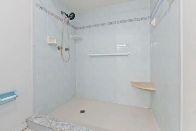 a bathroom with a bath tub and shower