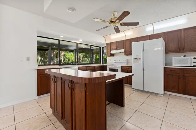 a kitchen with stainless steel appliances granite countertop a stove a refrigerator and a sink