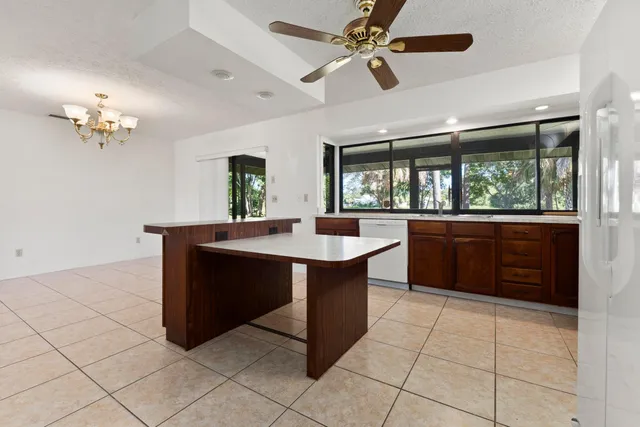 a kitchen with stainless steel appliances granite countertop a sink and a refrigerator