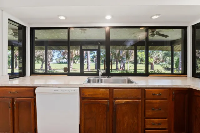 a kitchen with a sink and large window