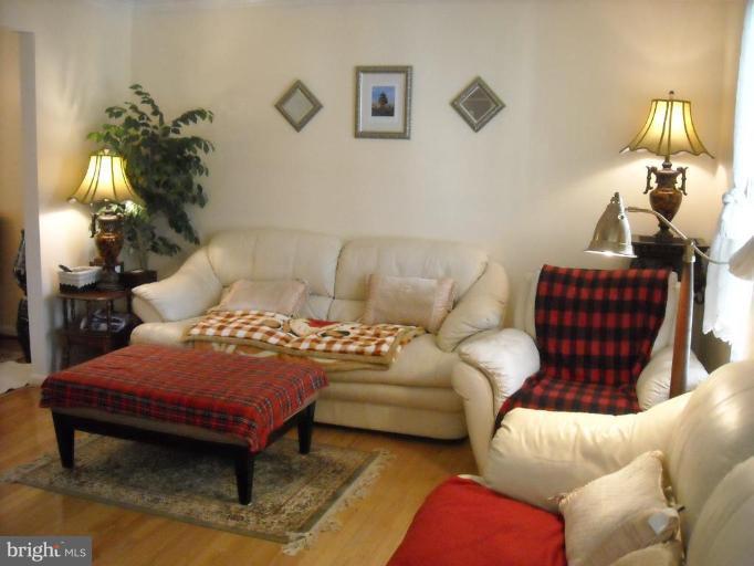 8612 Daytona Road Rosedale, MD 21237 - Photo 3 of 23 a living room with furniture a lamp and a potted plant