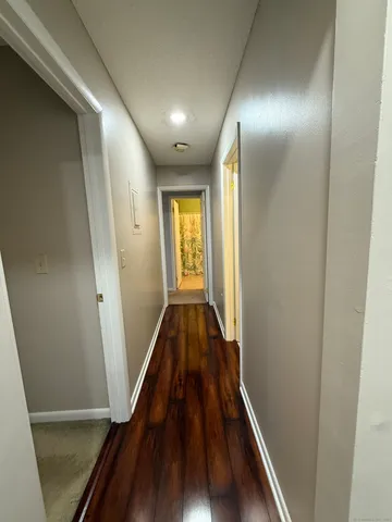 a view of hallway with wooden floor