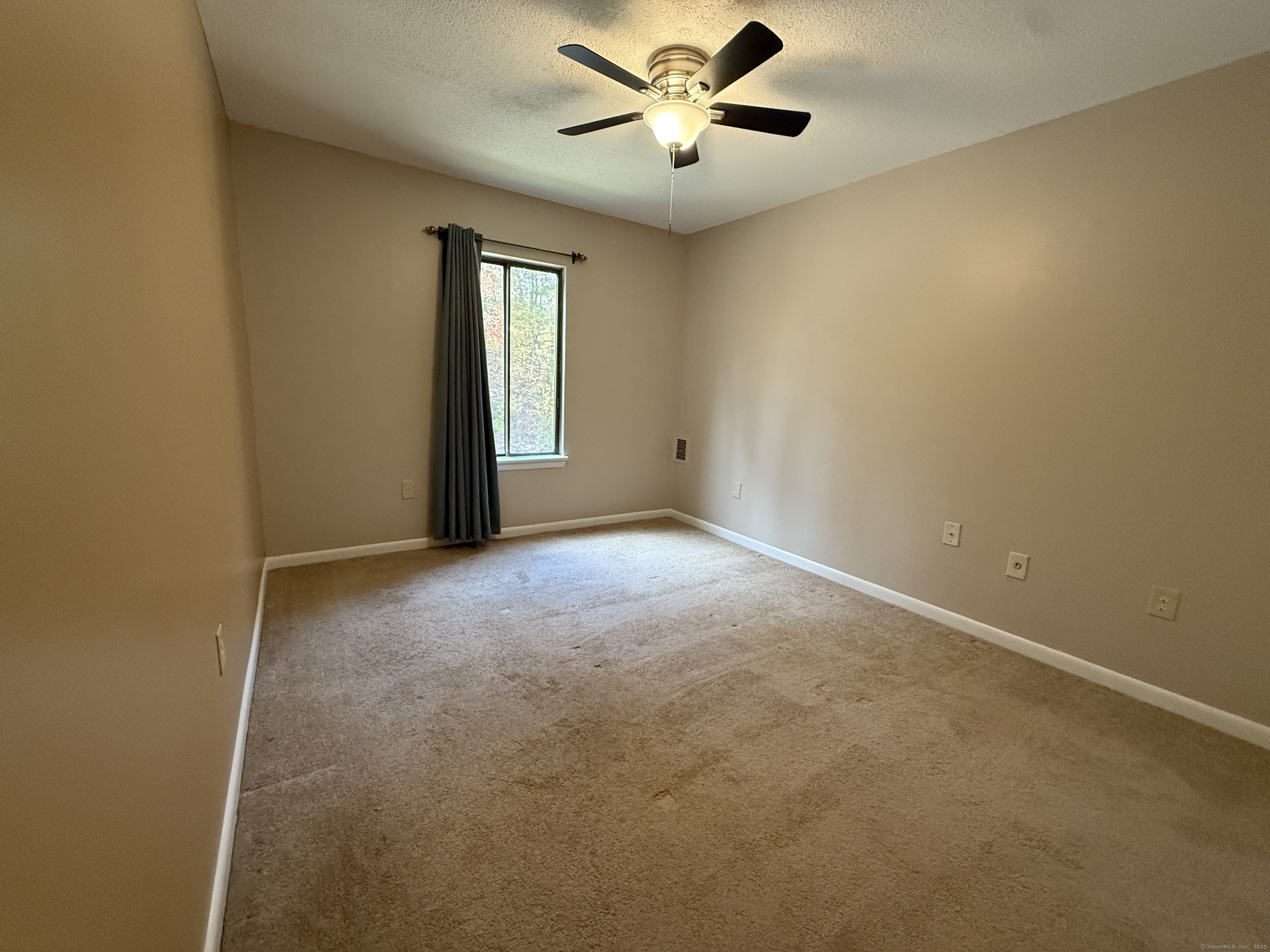 175 Mill Pond Road, Unit 215 Hamden, CT 06514 - Photo 8 of 19 a view of an empty room with a window