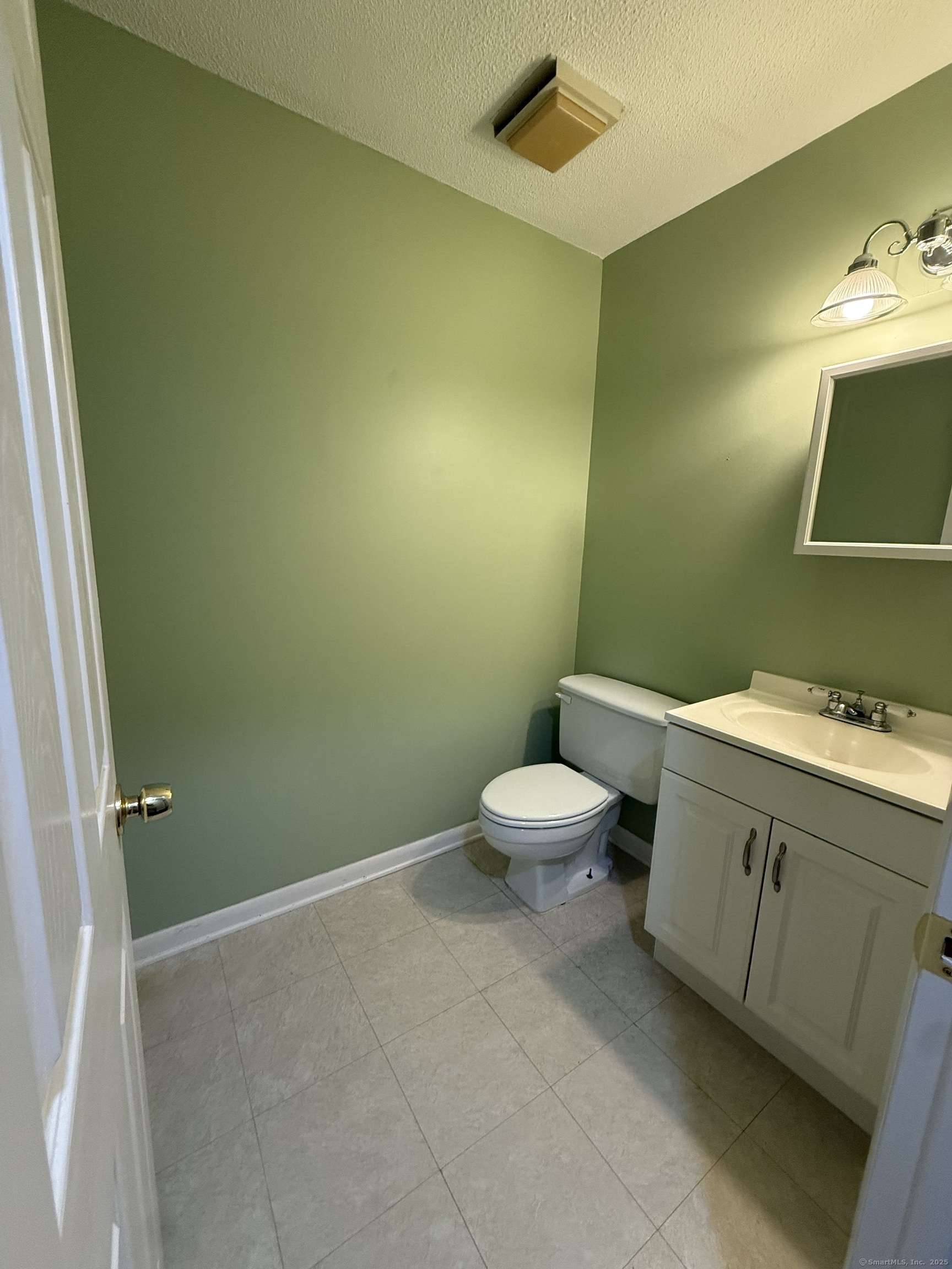 175 Mill Pond Road, Unit 215 Hamden, CT 06514 - Photo 10 of 19 a bathroom with a toilet sink and mirror